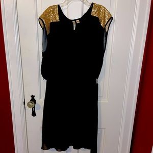 Black dress with gold sequin shoulders.